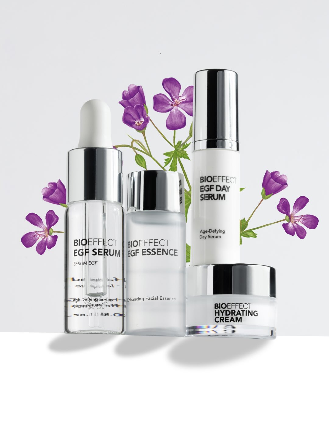 Coffret printanier Bioeffect EGF Serum Value Set présenté avec fleurs violettes, conçu pour revitaliser la peau, améliorer l’éclat du teint et soutenir la régénération cutanée.