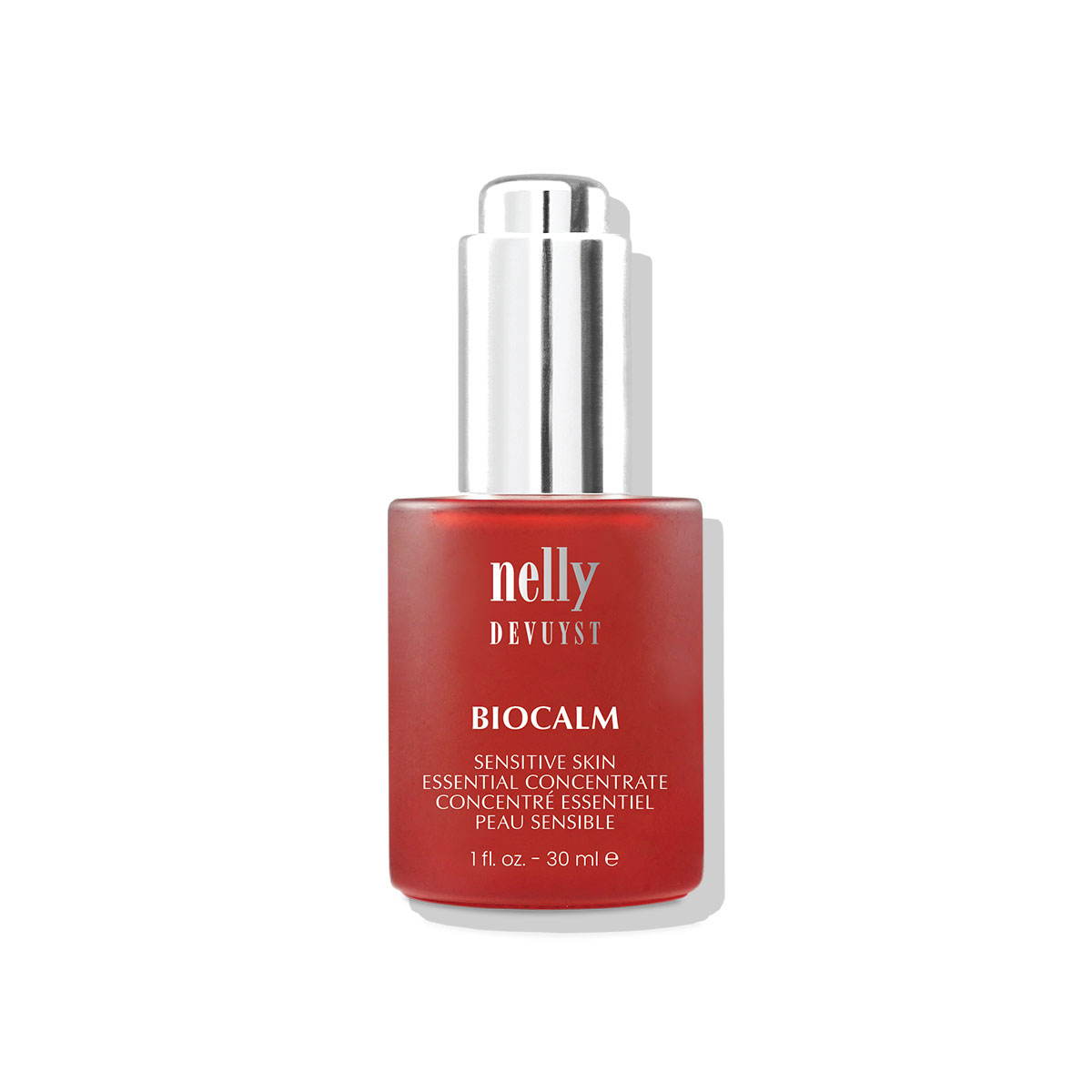 Flacon compte-gouttes rouge du Concentré Essentiel BioCalm Nelly Devuyst, soin apaisant pour peau sensible sujette à la rosacée acnéique, rougeurs et papules, 30 ml.