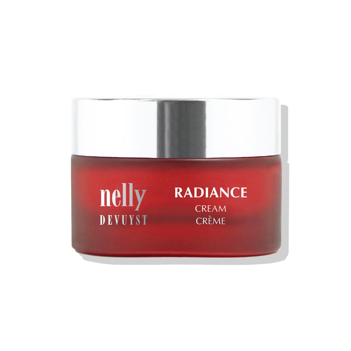 Pot rouge de la Crème Radiance Nelly DeVuyst, soin revitalisant et éclaircissant conçu pour lisser, hydrater et illuminer la peau au quotidien.