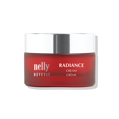 Pot rouge de la Crème Radiance Nelly DeVuyst, soin revitalisant et éclaircissant conçu pour lisser, hydrater et illuminer la peau au quotidien.