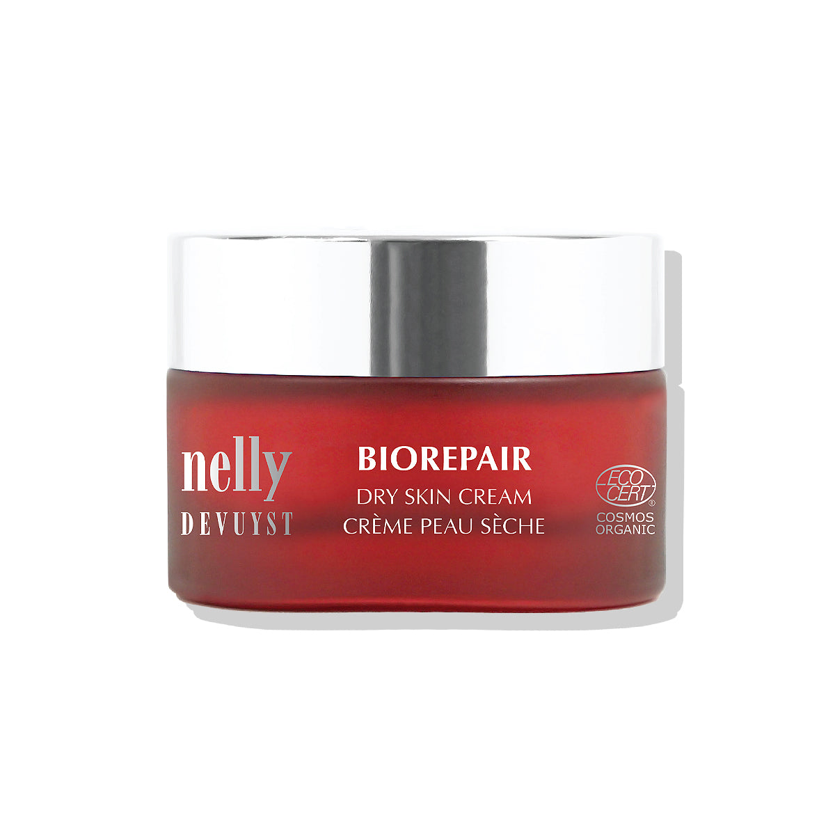 Pot rouge de la Crème Peau Sèche BioRepair Nelly DeVuyst, formule hydratante et réparatrice à base d’ingrédients biologiques pour une peau douce et revitalisée.