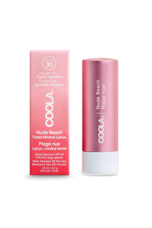 Baume à lèvres minéral FPS 30 Coola teinte Nude Beach avec boîte, protection solaire naturelle et hydratation pour des lèvres douces et lumineuses au fini rosé.